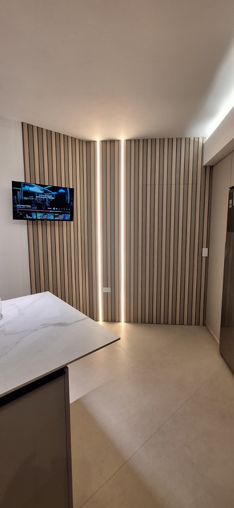 Recubrimiento Wall Panel WPC acanalado con tiras LED verticales empotradas y puerta secreta